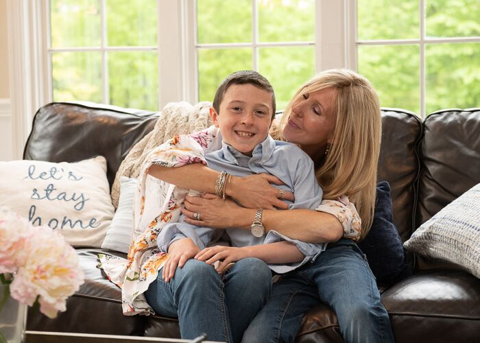 mom snuggle and holding char from behind on couch