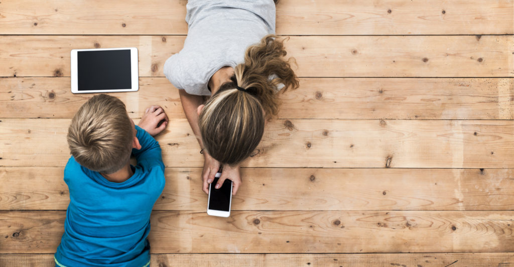 Boy and girl playing with mobile devices