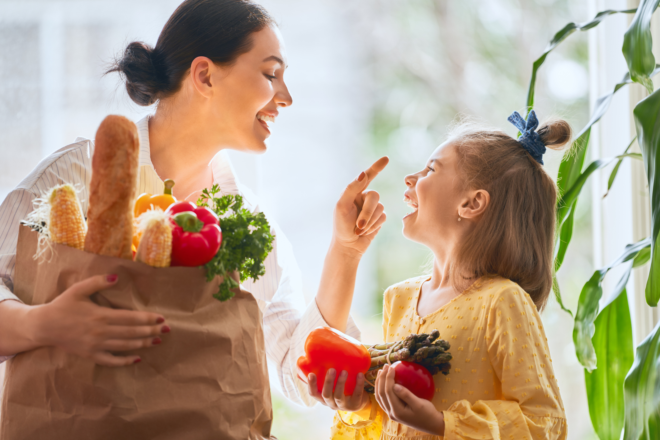 Mother and daughter holding shopping bag